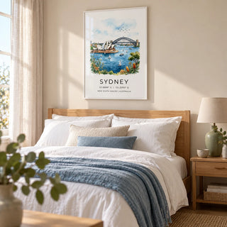Sydney Watercolor Art Print, framed on the wall of a peaceful coastal bedroom in a UK home with a pale sand wall and simple linen curtains