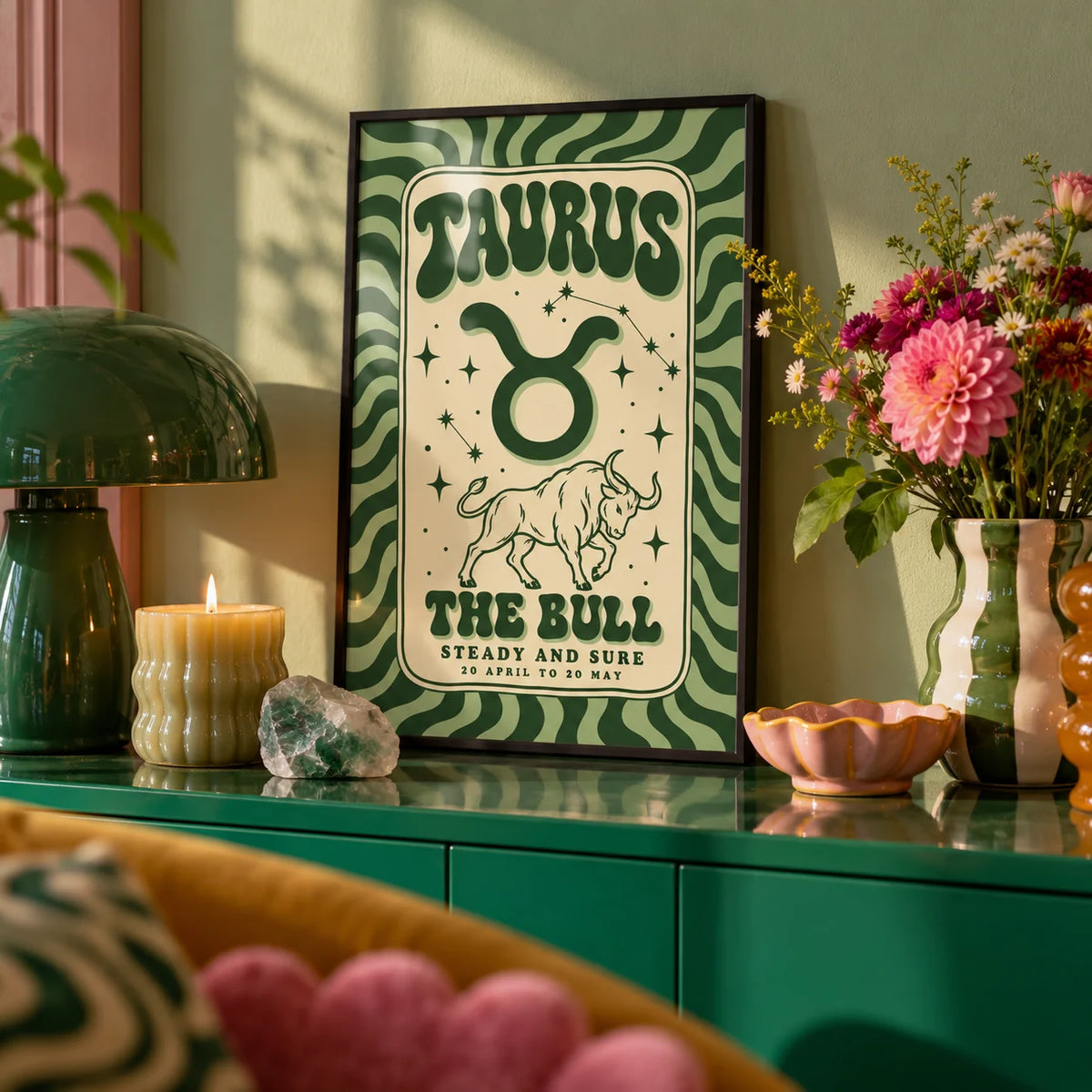 Taurus Print, a small A4 framed print leaning on a colourful lacquered shelf in a living room