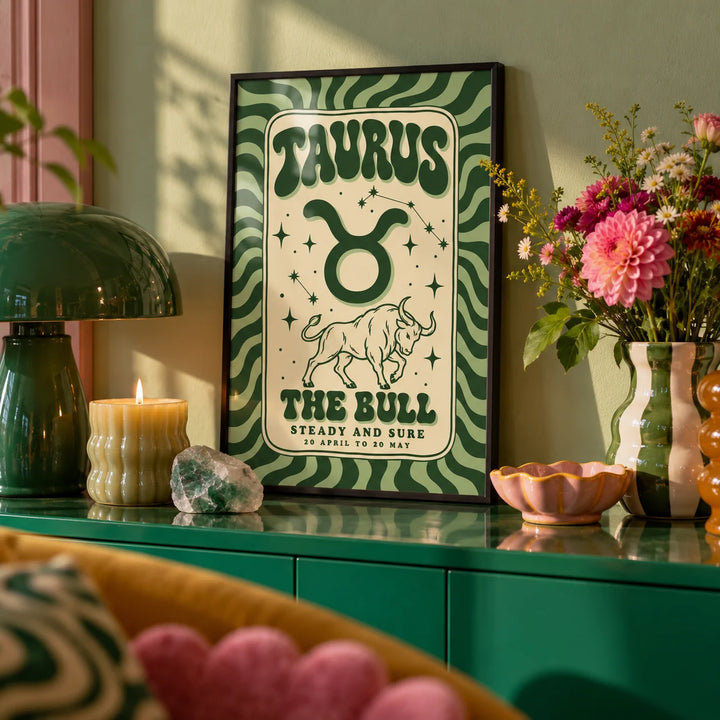 Taurus Print, a small A4 framed print leaning on a colourful lacquered shelf in a living room
