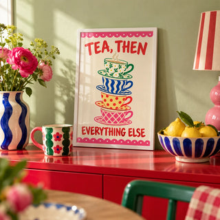 Teacup Tower Print, a small A4 framed print leaning on a colourful lacquered shelf in a living room