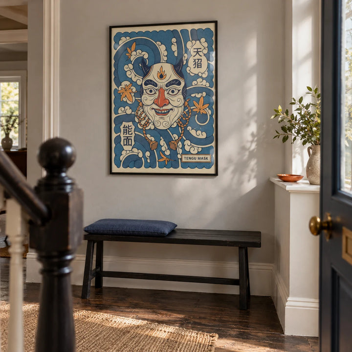 Tengu Mask Art, framed on the wall of a characterful entrance hallway in a renovated UK terrace with pale grey plaster walls and dark timber floorboards