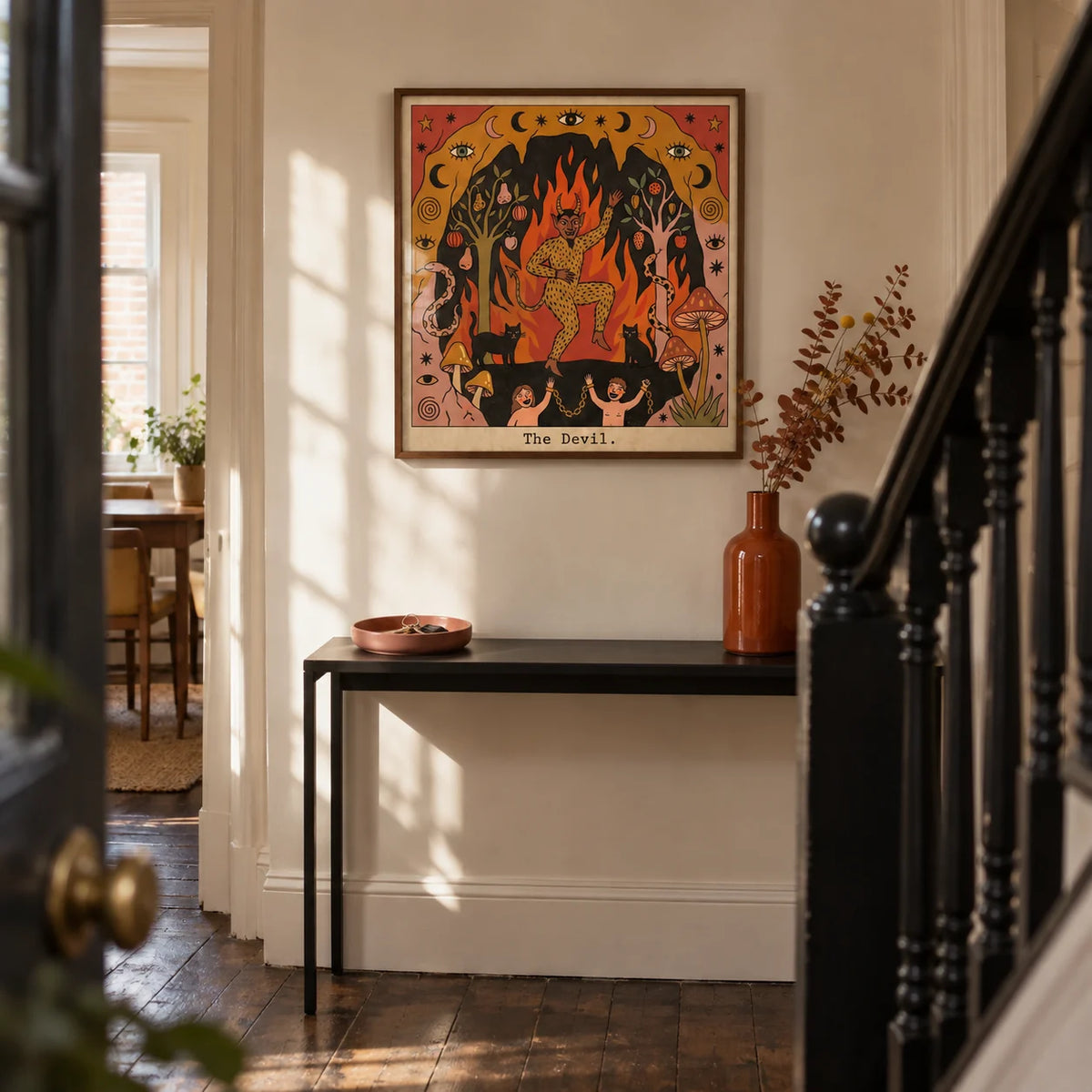 The Devil Tarot Card Art, framed on the wall of a narrow hallway in a UK terraced house with warm cream walls