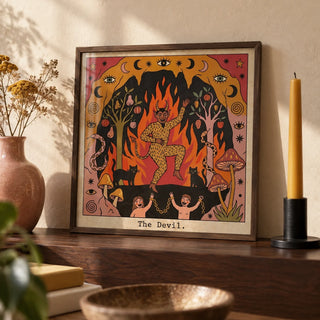 The Devil Tarot Card Art, a small A4 framed print leaning on a dark walnut shelf in a living room