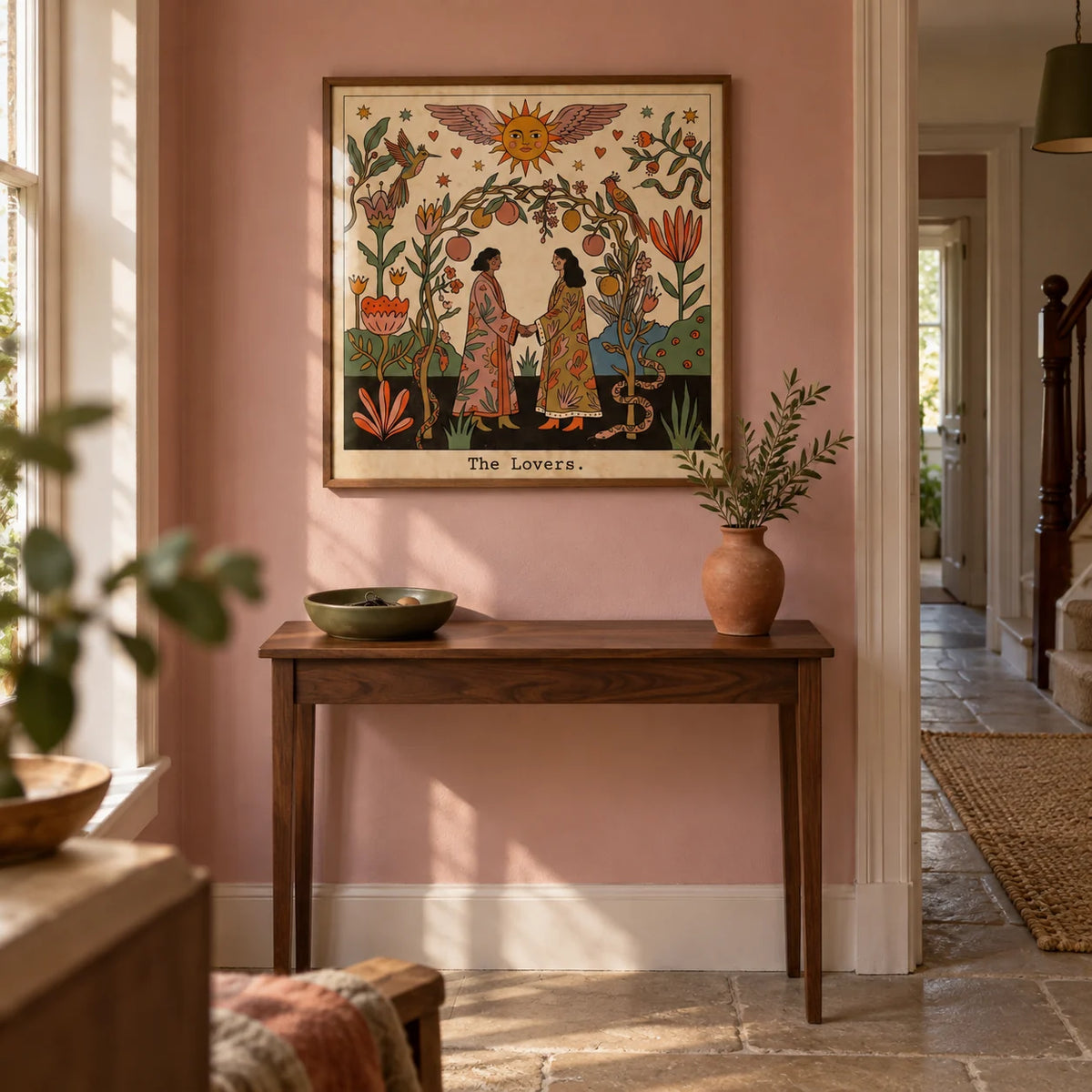 The Lovers Tarot Card Art, framed on the wall of a welcoming hallway in a modest UK period home with dusty pink painted walls and plain stone flooring