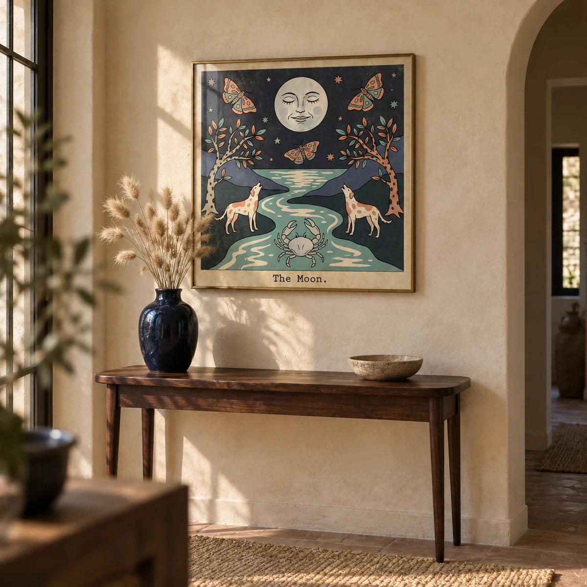 The Moon Tarot Card Art, framed on the wall of a characterful hallway with a beige limewashed wall and a plain arched doorway