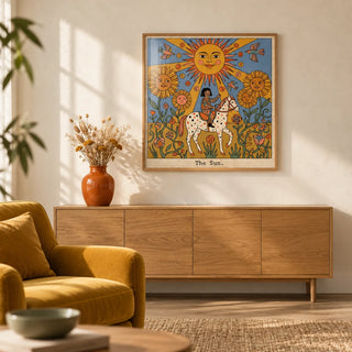 The Sun Tarot Card Art, framed on the wall of a warm boho-modern living room with a plain cream limewashed wall