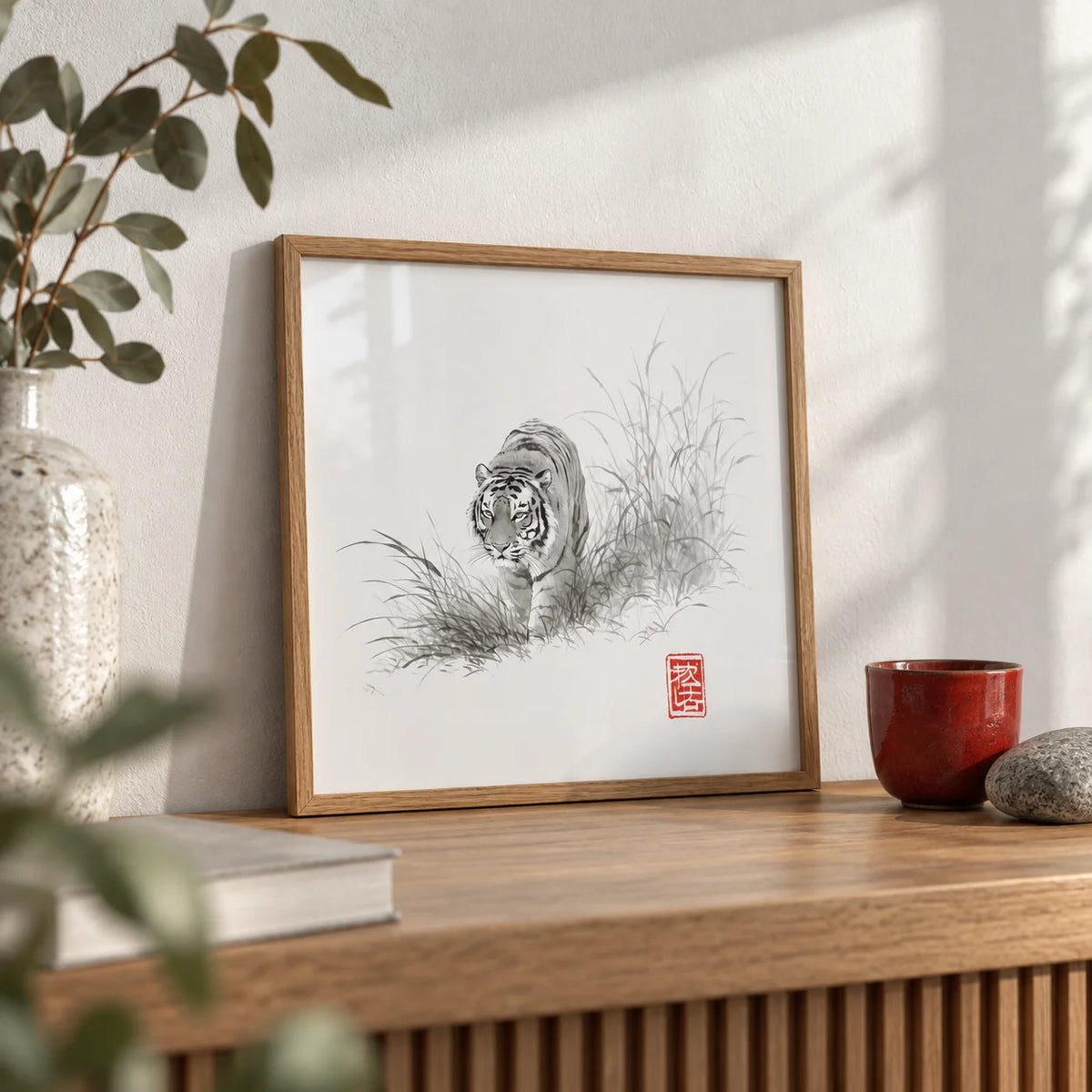 Tiger Ink Painting, a small A4 framed print leaning on an oak shelf in a living room