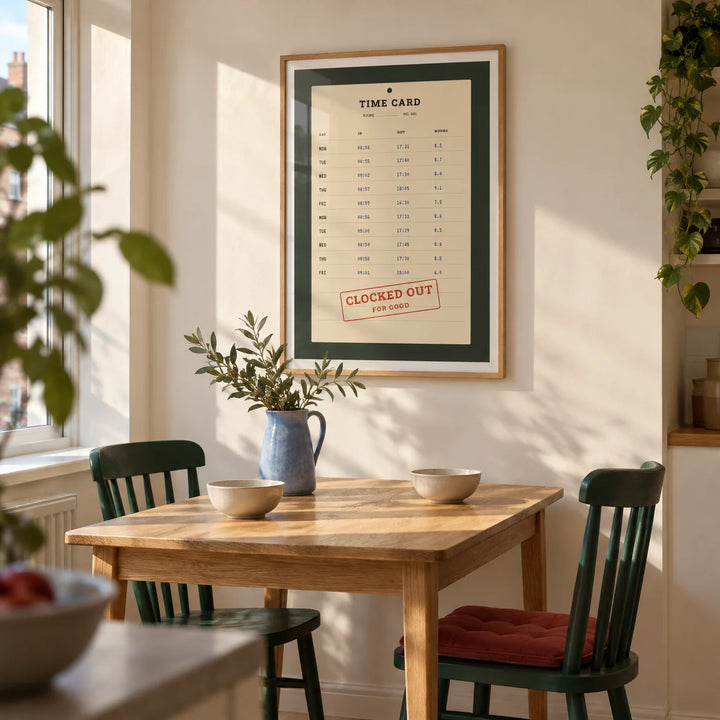 Time Card Print, framed on the wall of a compact modern dining nook in a British flat with a cream wall and pale oak floor