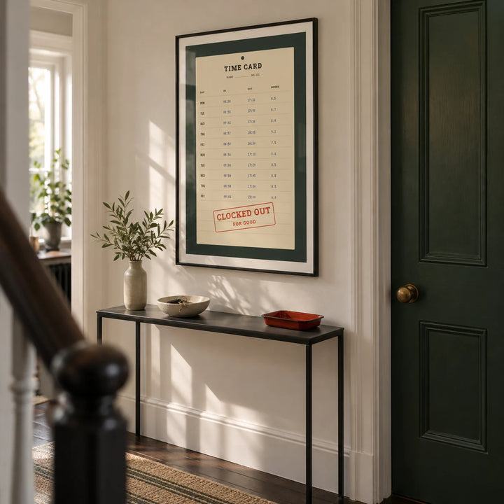 Time Card Print, framed on the wall of a narrow hallway in a renovated UK terrace with warm white walls and dark timber floorboards