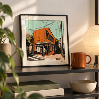 Tokyo Wall Art, a small A4 framed print leaning on a black metal shelf in a living room
