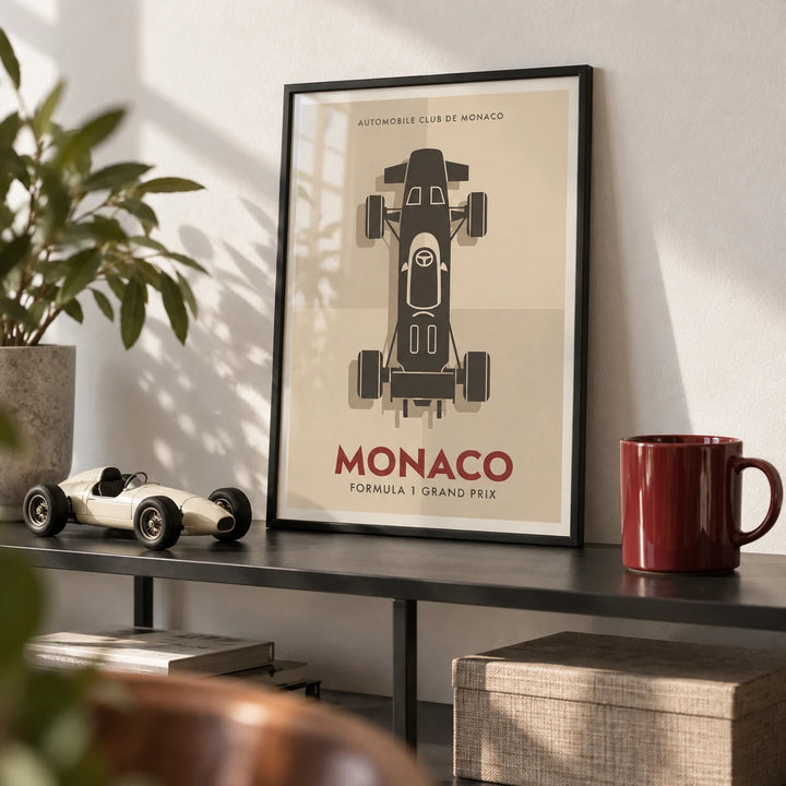 Top-Down Racing Car Poster, a small A4 framed print leaning on a black metal shelf in a living room