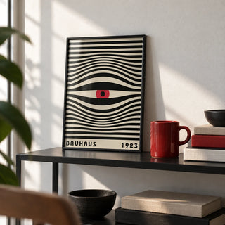 Trippy Wall Art, a small A4 framed print leaning on a black metal shelf in a living room