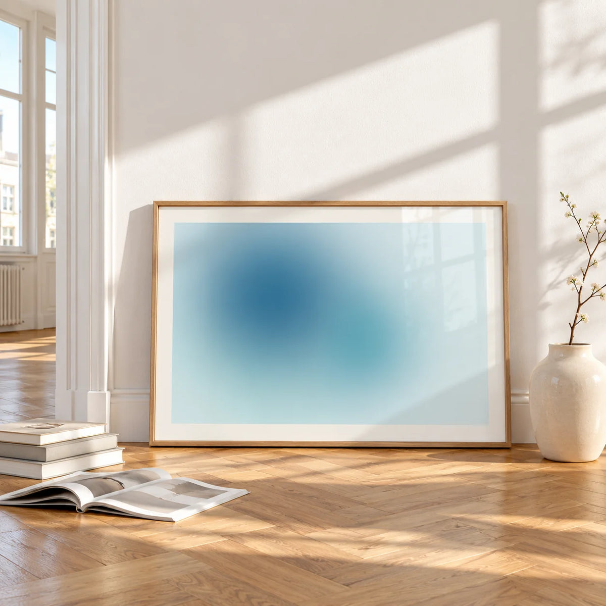 Turquoise Wall Art, framed and leaning on the parquet floor of a bright living room