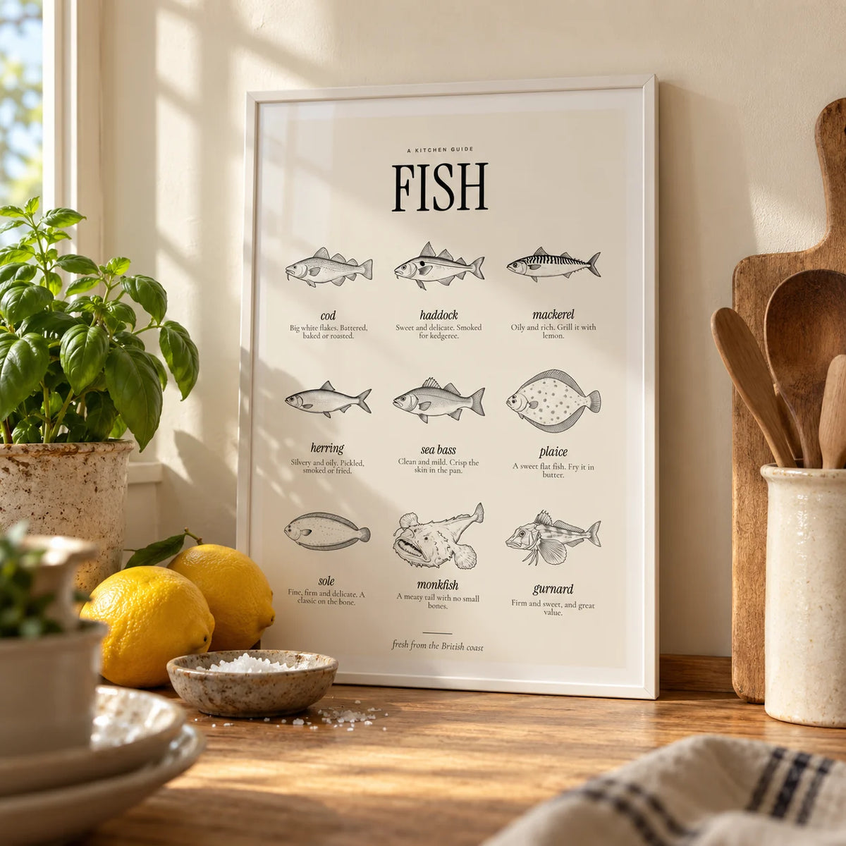 Types of Fish Print, a small A4 framed print leaning on an oak worktop in a kitchen