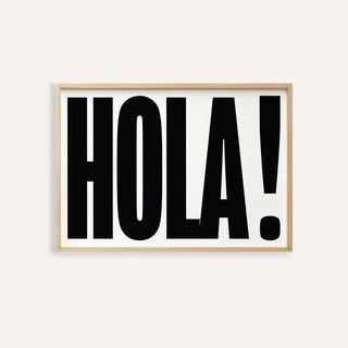 Framed print close-up of typographic posters with bold black hola on white background