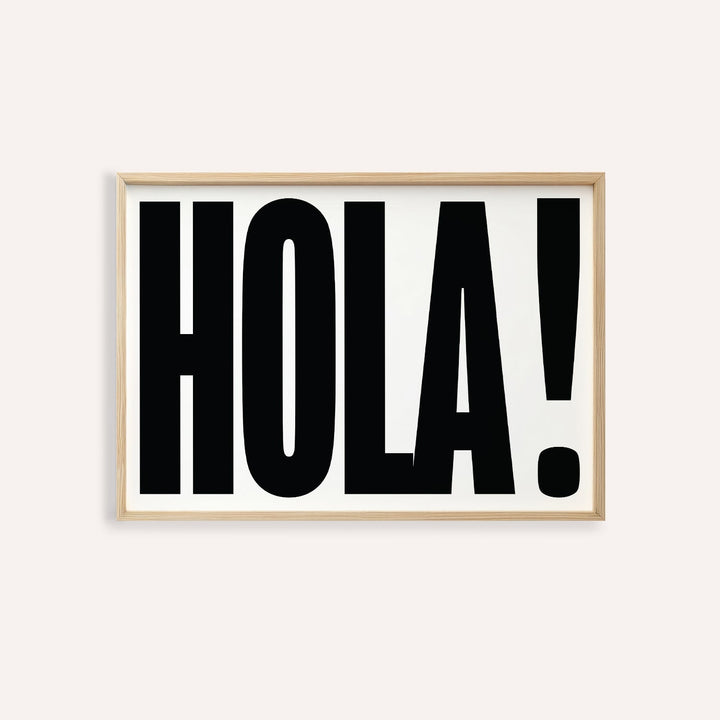 Framed print close-up of typographic posters with bold black hola on white background