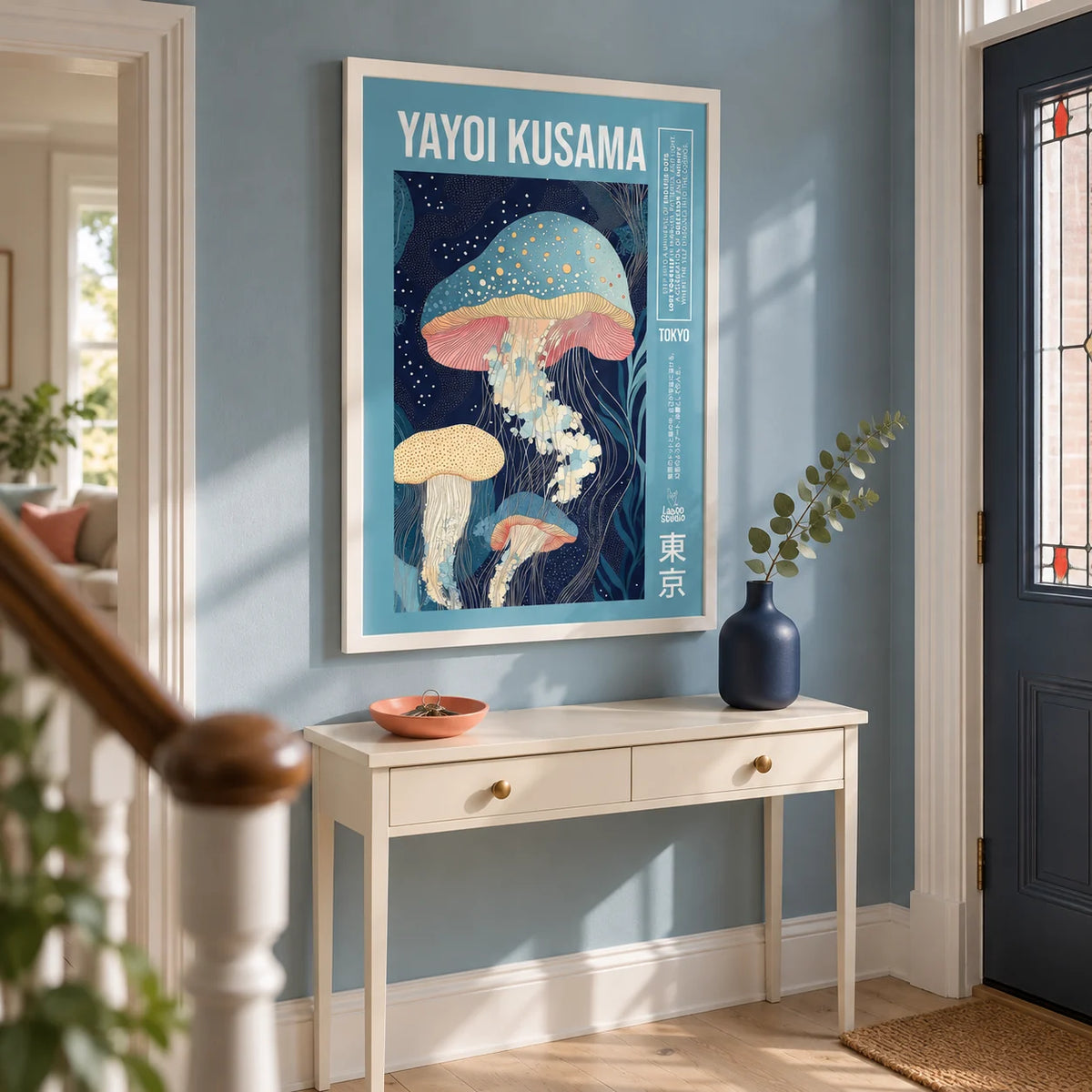 Unique Art Prints, framed on the wall of a bright entrance hallway in a UK terraced home with a muted blue wall and pale timber floor