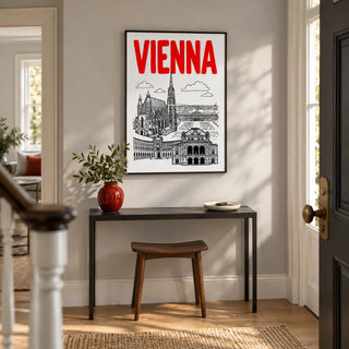 Vienna Cityscape Print, framed on the wall of a bright entrance hallway in a UK townhouse with a pale grey wall and plain oak flooring