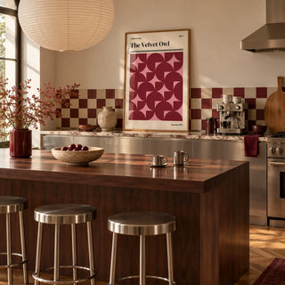 Vintage Bath Poster, framed on the wall of a warm kitchen with a burgundy and cream checkerboard tile splashback and brushed steel cabinets
