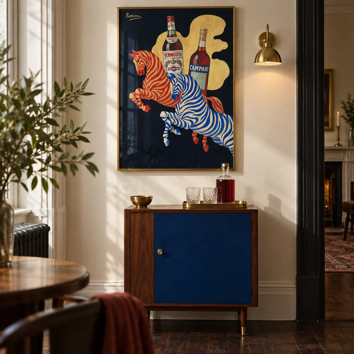 Vintage Beverage Art, framed on the wall of a characterful home bar corner in a UK Victorian terrace with a warm ivory wall and dark timber floor in a living room