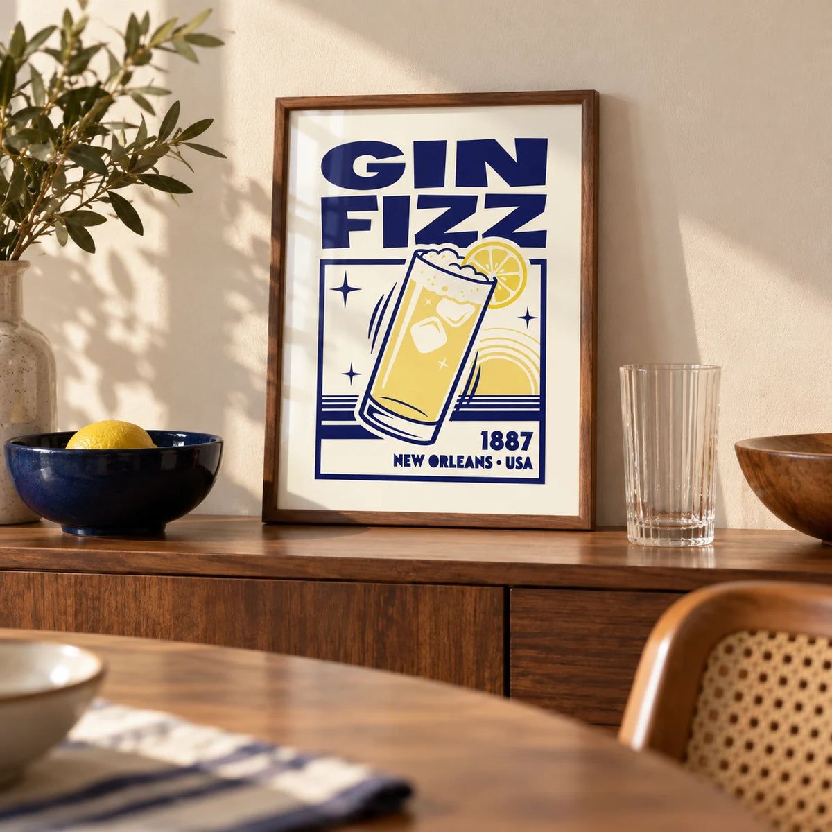 Vintage Gin Fizz Print, a small A4 framed print leaning on a walnut sideboard in a dining room