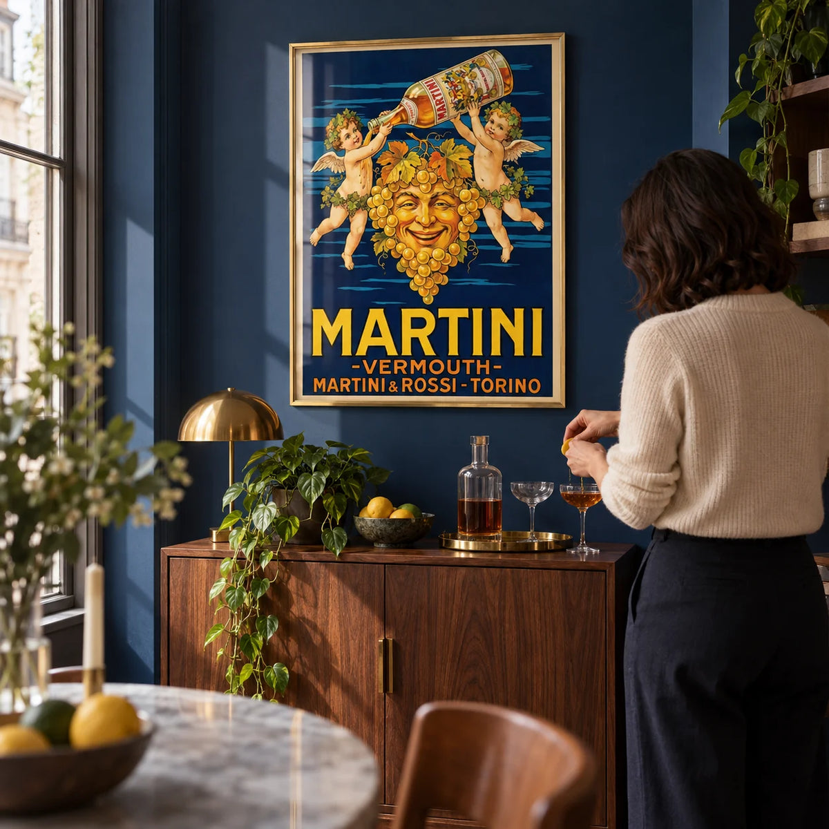 Vintage Vermouth Poster, framed on the wall of a compact home bar alcove in a characterful city flat with deep navy walls and a walnut drinks cabinet in a living room