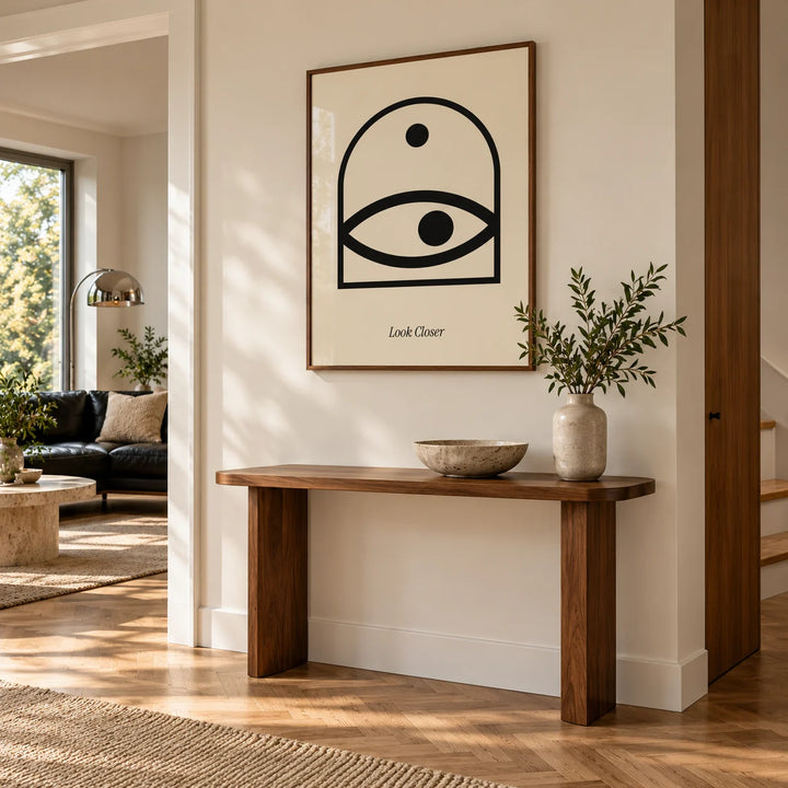 Wall Art Eye, framed on the wall of a hallway with a walnut side table