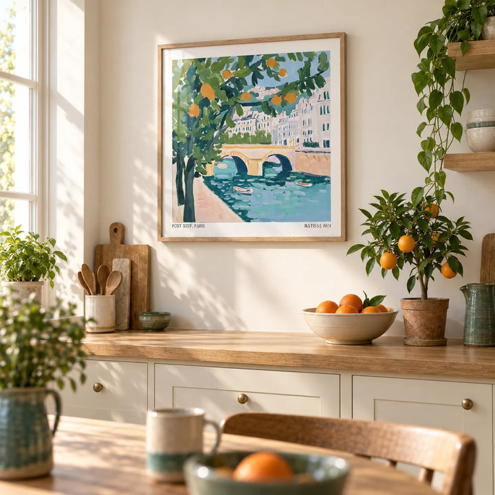 Wall Art of Paris, framed on the wall of a sunny kitchen with plain cream cabinets and an oak worktop