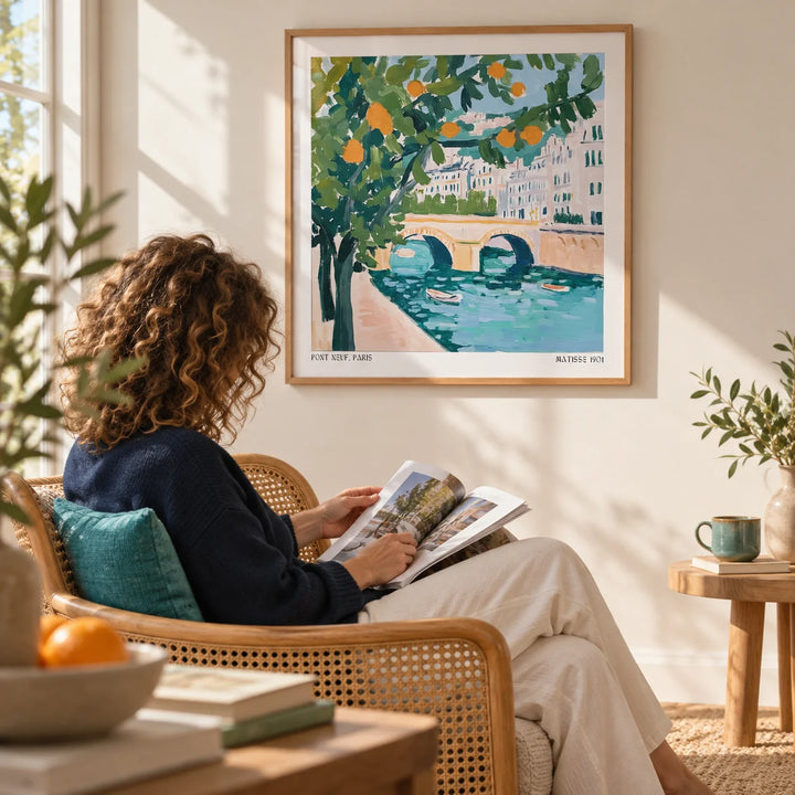 Wall Art of Paris, framed on the wall of a sunny reading corner with a warm white wall in a living room