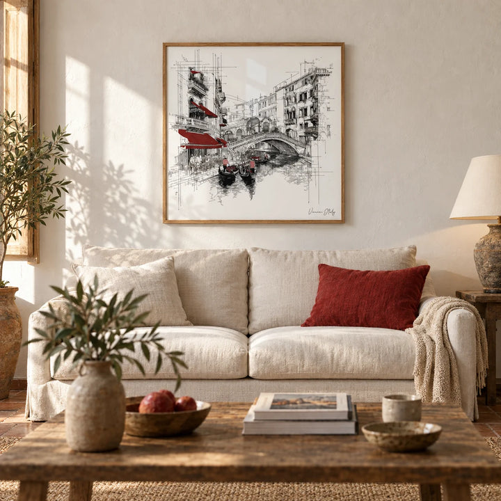 Wall Art of Venice Italy, framed on the wall of a warm Italian-style living room with a soft white plaster wall and an old terracotta floor