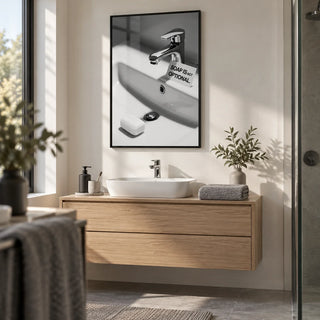 Wash Hands Sign, framed on the wall of a modern en-suite with plain warm white walls in a bathroom