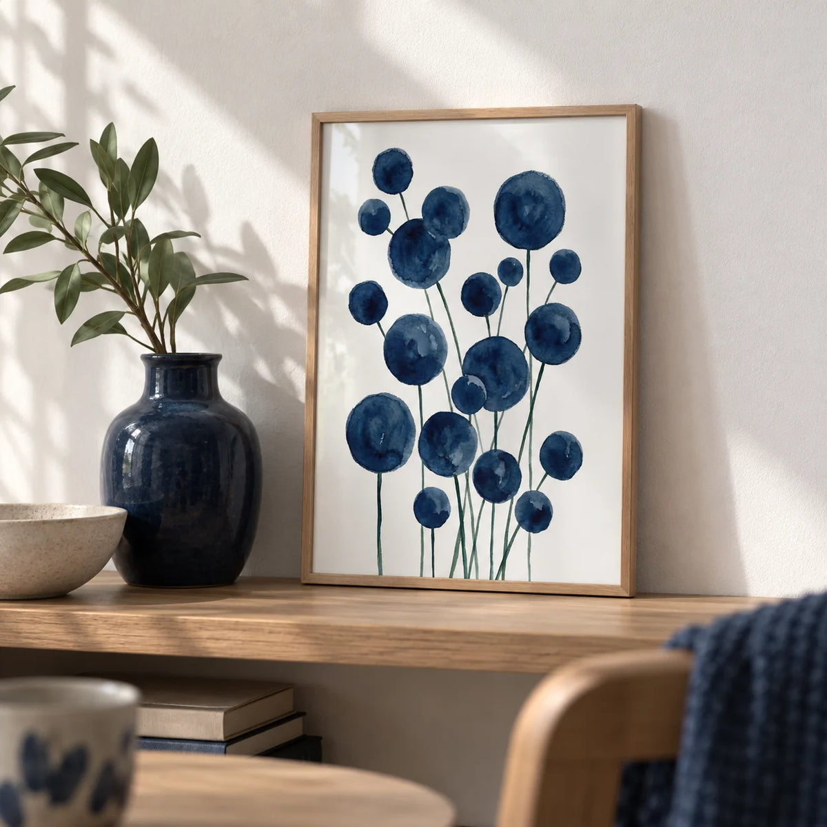 Watercolor Flower Print, a small A4 framed print leaning on an oak shelf in a living room