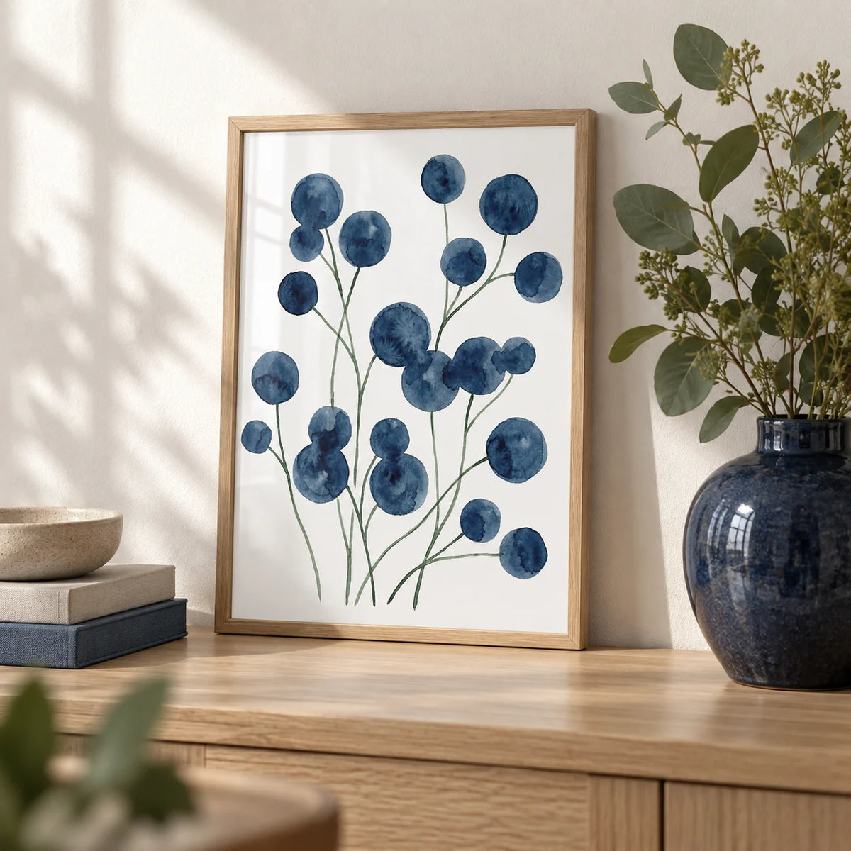 Watercolor Flower Wall Art, a small A4 framed print leaning on a pale oak shelf in a living room