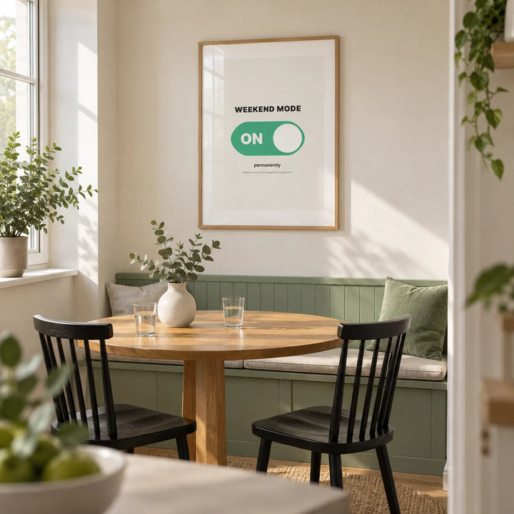 Weekend Poster, framed on the wall of a compact modern dining nook in a UK maisonette with a warm white wall and a built-in mint-green bench