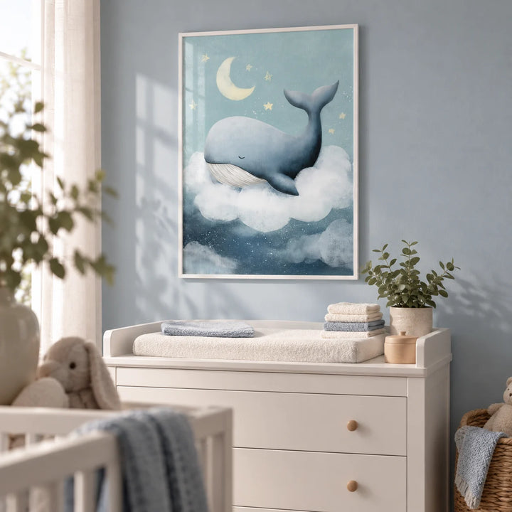 Whale Nursery Wall Art, framed on the wall of a tidy nursery with a pale blue-grey wall