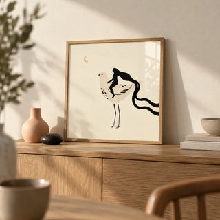 Whimsical Bird Art Print, a small A4 framed print leaning on an oak sideboard in a living room