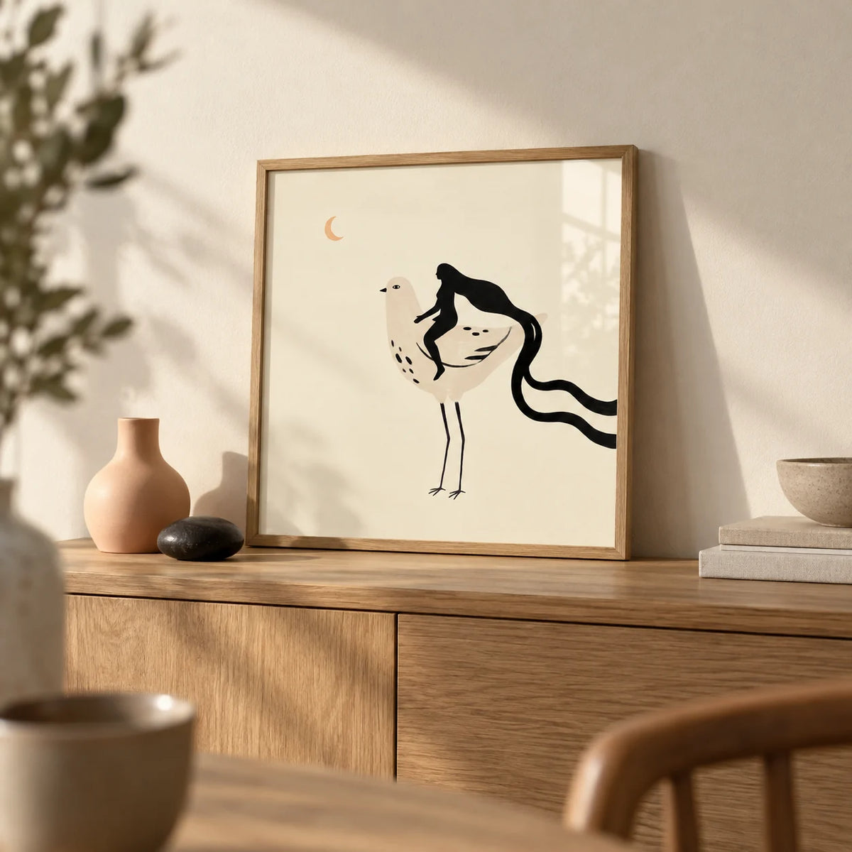 Whimsical Bird Art Print, a small A4 framed print leaning on an oak sideboard in a living room