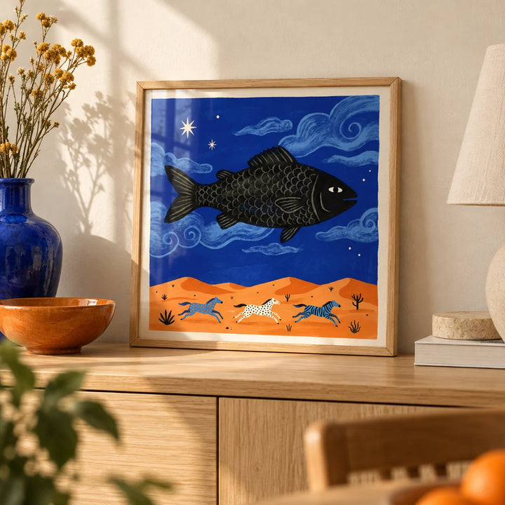Whimsical Fish Art Print, a small A4 framed print leaning on a pale oak sideboard in a living room