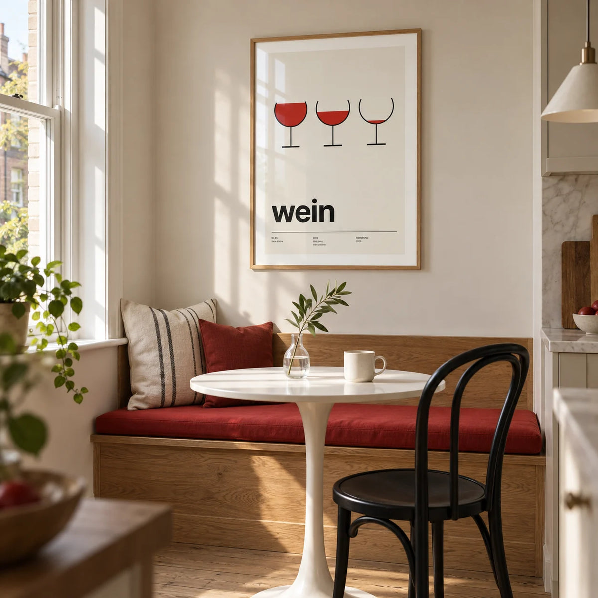 Wine Poster, framed on the wall of a small kitchen breakfast nook in a renovated UK terrace with a soft off-white wall and a built-in oak bench