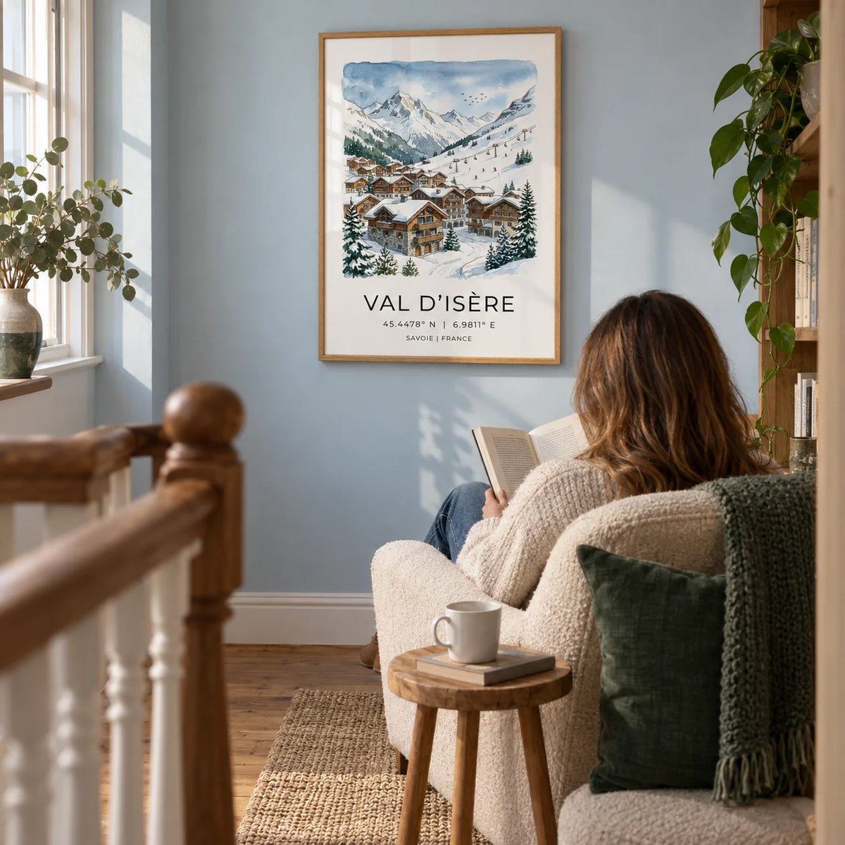 Winter Landscape Art Print, framed on the wall of a cosy landing reading nook in a UK cottage with a pale blue wall and warm timber floorboards in a living room