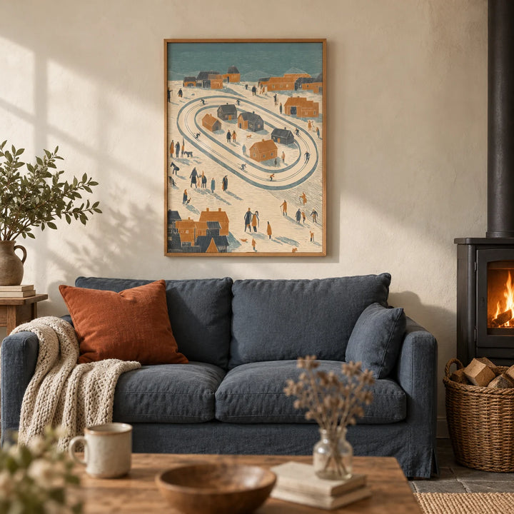 Winter Village Art Print, framed on the wall of a cosy cottage living room with a cream limewashed wall