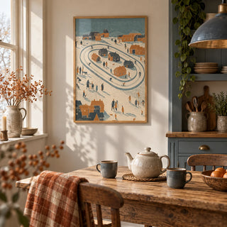 Winter Village Art Print, framed on the wall of a warm country kitchen with slate blue cabinets