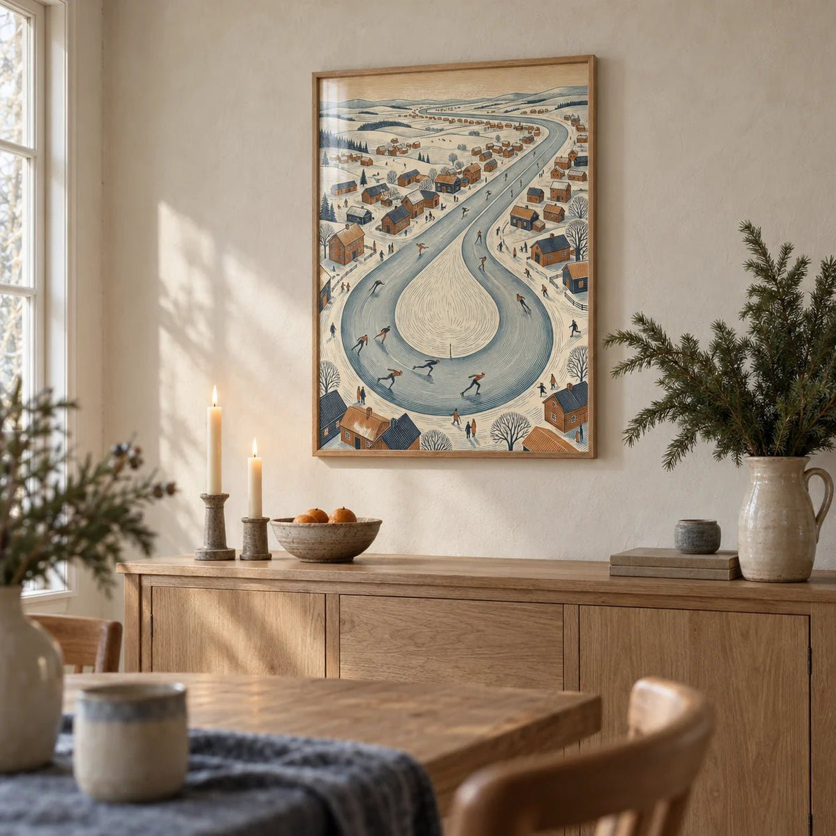 Winter Village Scene, framed on the wall of a cottage dining room with a cream limewashed wall