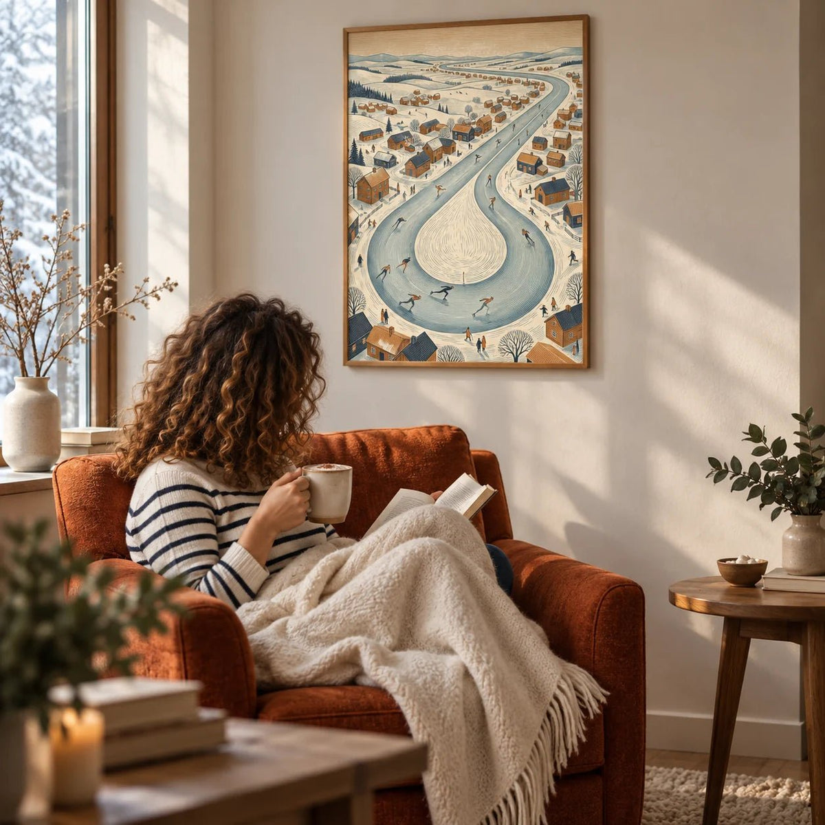 Winter Village Scene, framed on the wall of a reading nook by a frosty window in a living room