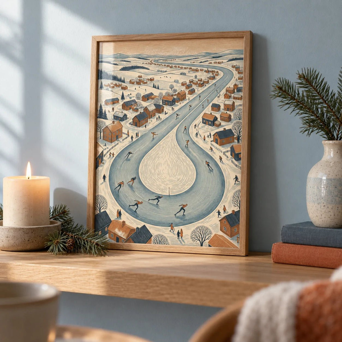 Winter Village Scene, a small A4 framed print leaning on an oak shelf in a living room