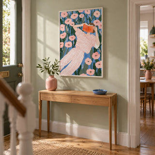 Woman Reading Art Print, framed on the wall of a welcoming hallway in a modest UK terrace with pale sage walls and natural oak floorboards