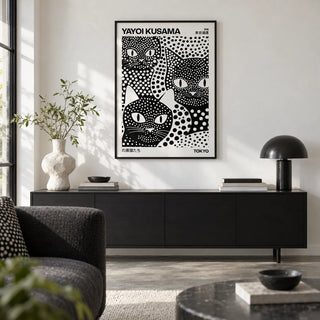 Yayoi Kusama Black Cats, framed on the wall of a design-led city flat living room with a white wall and a polished concrete floor