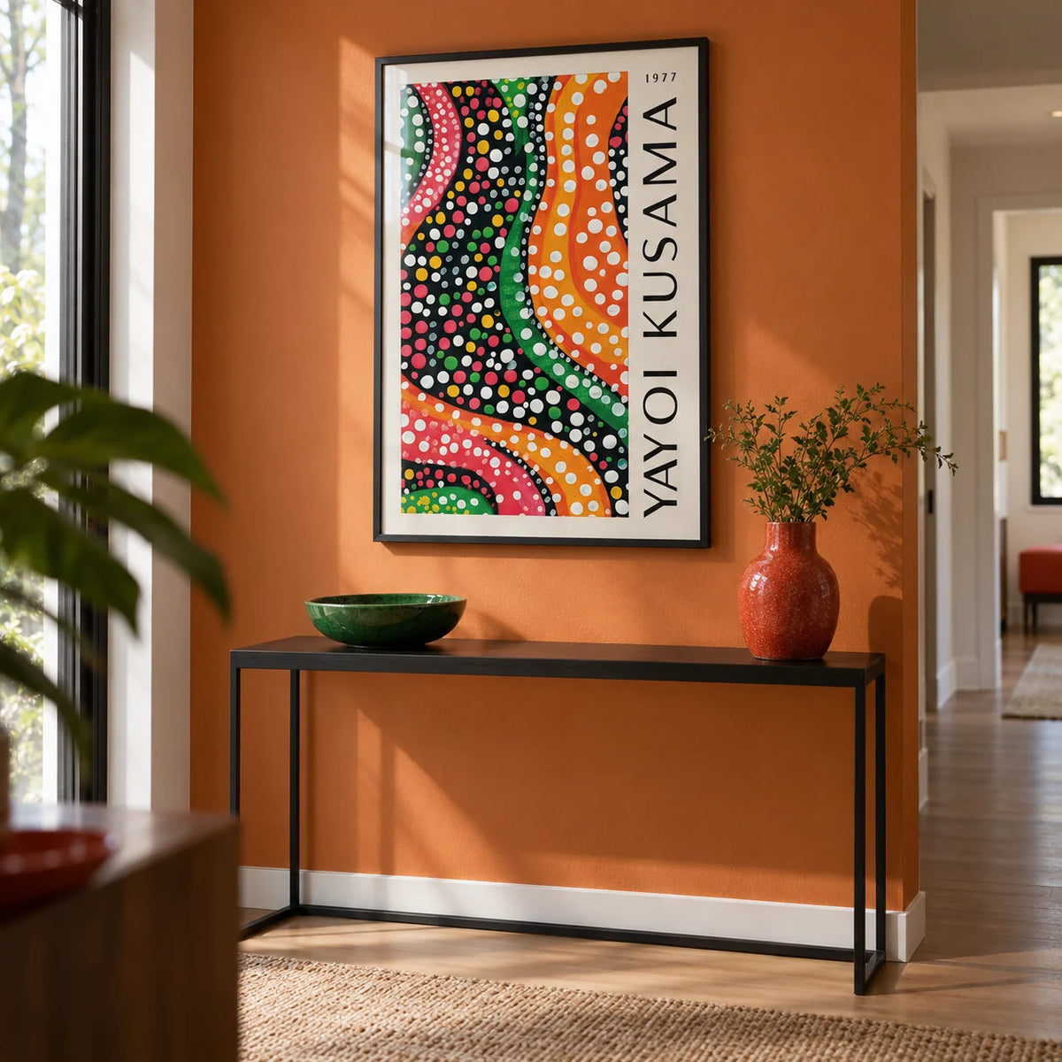 Yayoi Kusama Dots, framed on the wall of a modern hallway with an orange painted wall