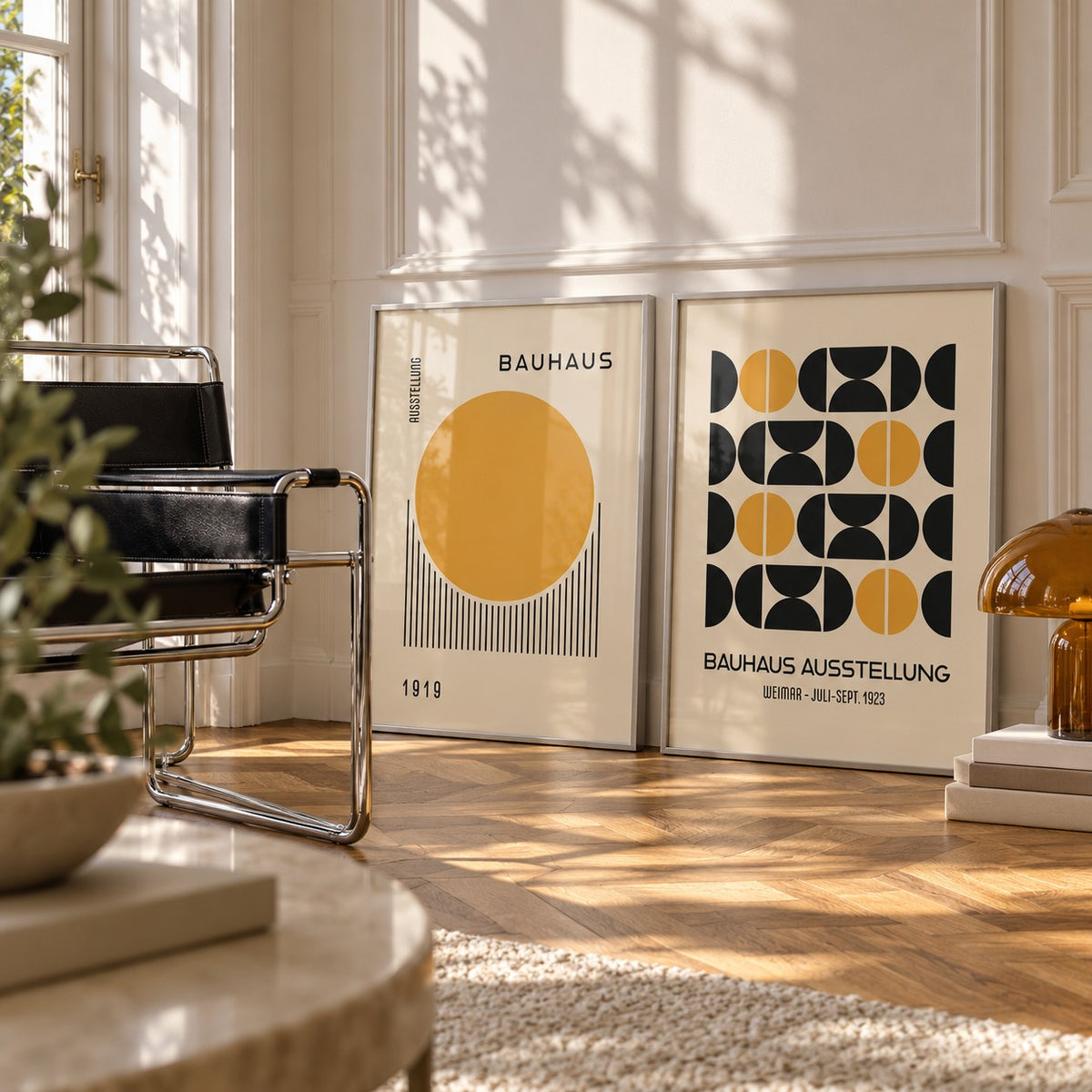 Yellow and Black Bauhaus Prints Set of 2 styled leaning in a white corner next to a black leather sling chair and an amber lamp: Golden Dawn and Bauhaus Symmetry shown framed side by side (frames not included)