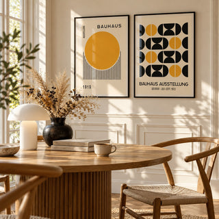 Yellow and Black Bauhaus Prints Set of 2 styled above a round fluted oak dining table with a mushroom lamp: Golden Dawn and Bauhaus Symmetry shown framed side by side (frames not included)